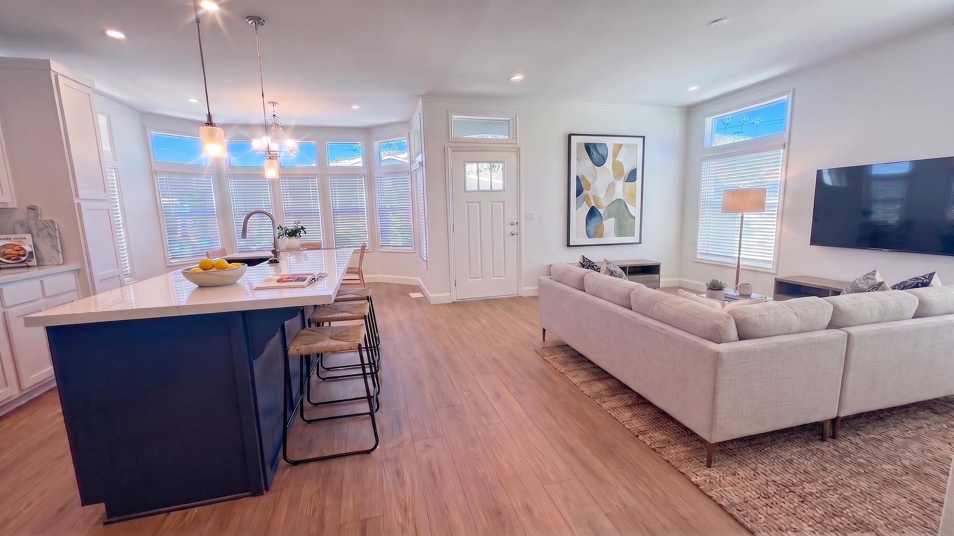 Open-concept living room and kitchen island with sectional sofa, Space 117 Beachwood Village mobile home, Dana Point CA